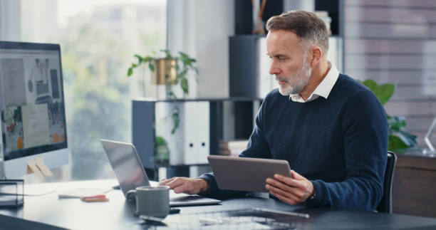 Digital, online and internet analysis with modern technology of a senior fintech analyst working. Old IT web software and website developer programming big data and cloud computing research systems