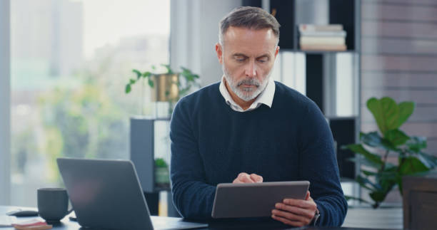 istock Businessman working on digital tablet, planning marketing strategy and research for ideas for startup company in office at work. Manager, boss and employee networking online and reading emails 1419662974