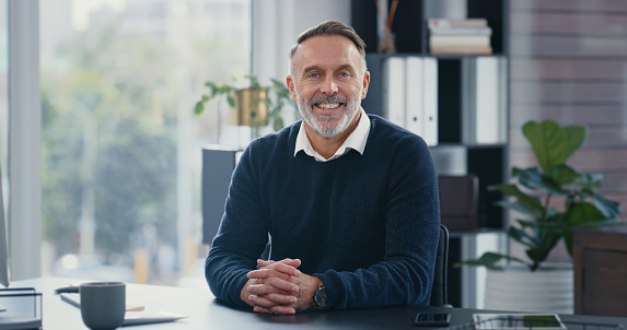 Mature ceo, office desk and portrait of man inside business building. Professional and happy working person in leadership and management. Corporate boss who is assertive and positive in their career.