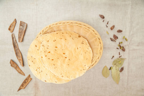 Papad roti served in a basket isolated on table top view of indian spices food stock photo