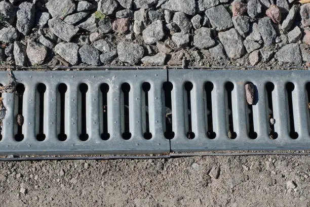Photo of long gray metal grate for draining water