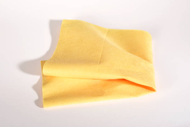 Folded yellow cleaning cloth on the white background