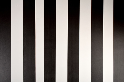 Seamless background of black and white parallel vertical lines, front view wallpaper decoration