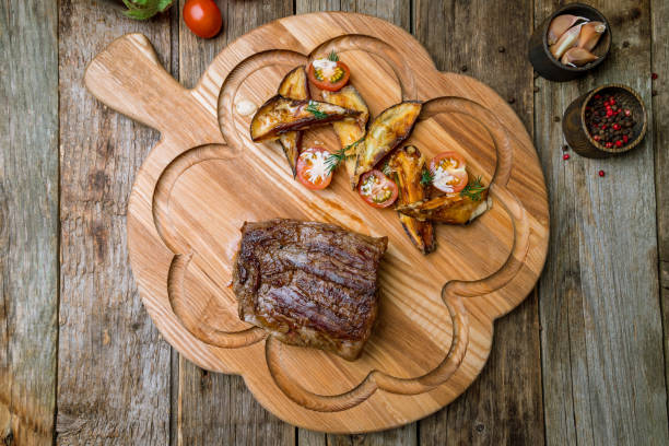 istock roast beef Steak with auberdine on the board top view 1419669346