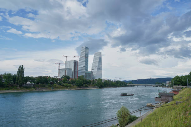roche towers basel with rhine river. Kleinbasel banks of the Rhine The Rochetürme Basel with the Rhine in the foreground. On the Rhine is the St. Alban ferry (Wildmaa ferry) The sky is slightly cloudy and summery warm. In the direction of Birsfelden and Birsfelden power plant comerica park photos stock pictures, royalty-free photos & images