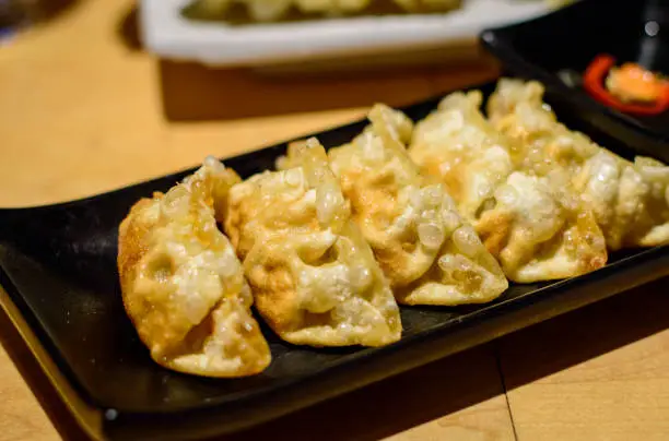 Delicious Japanese deep fried gyoza (dumplings) placed on the restaurant's table.