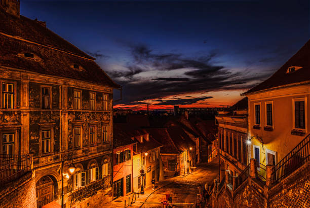 calle medieval del casco antiguo inferior de sibiu por la noche - europe bridge editorial eastern europe fotografías e imágenes de stock