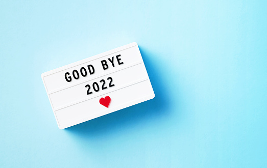 Good Bye 2022 written white lightbox sitting on blue background. Horizontal composition with copy space.