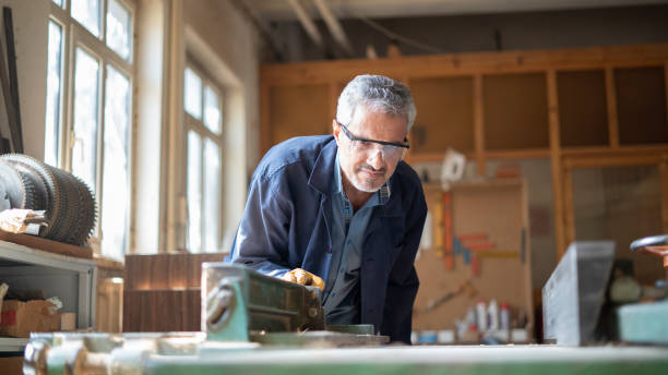 istock Woodworker cutting wood on electric machine 1419680537