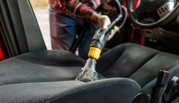 istock Worker using professional vacuum-cleaner for deep washing driver car seat. 1419681346