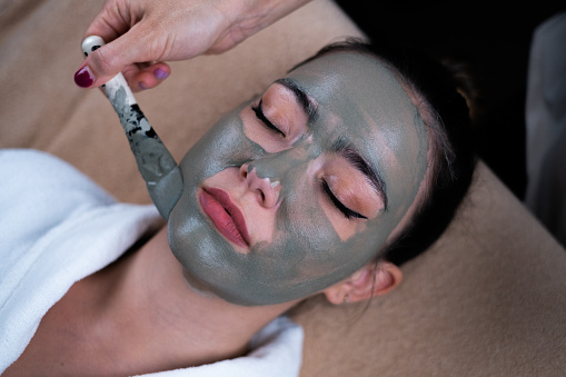 Facial beauty seaweed treatment on young woman.