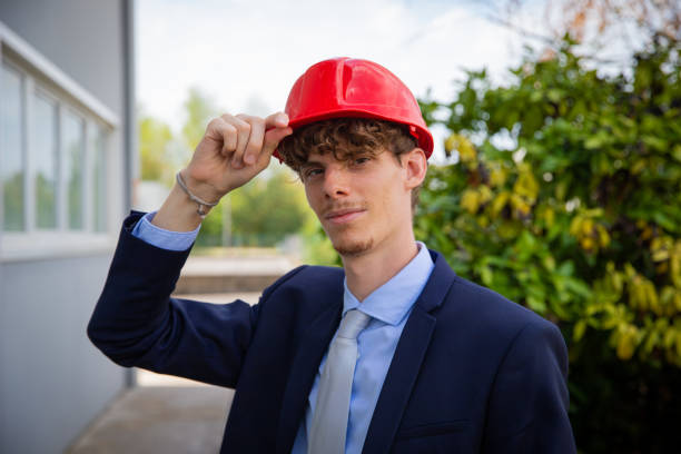istock Portrait of a smartly dressed successful engineer holding protective helmet with his hand. 1419684166