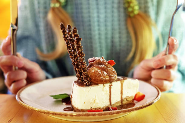 istock Cheesecake on a plate in a cafe close-up. Fresh appetizing cheesecake on a plate. Selective focus 1419685468