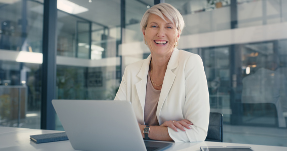 Happy and proud business manager, entrepreneur and leader working on a laptop with a smile in an office. Portrait of an accounts executive, hr manager and administrator in a corporate startup agency