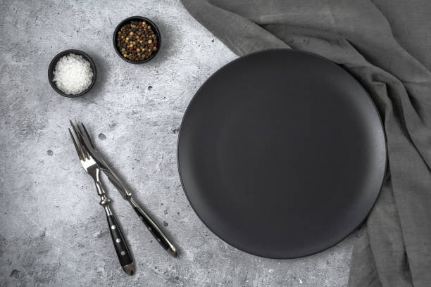 istock Empty black slate plate on grey stone table and napkin. 1419691999
