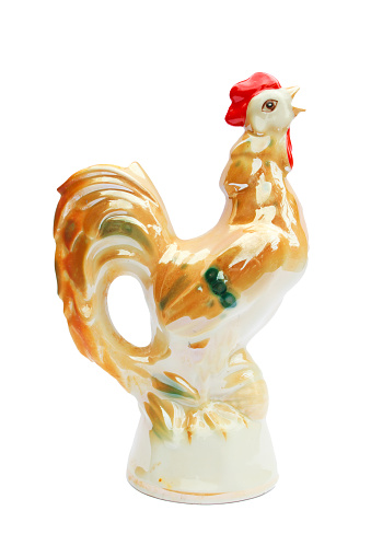 Porcelain figurine of a rooster on a white background.