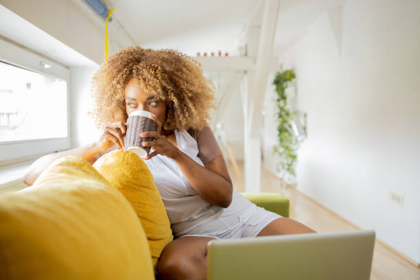 istock Beautiful woman relaxing and drinking hot tea 1419697024