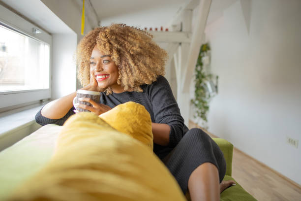 istock Beautiful woman relaxing and drinking hot tea 1419697034