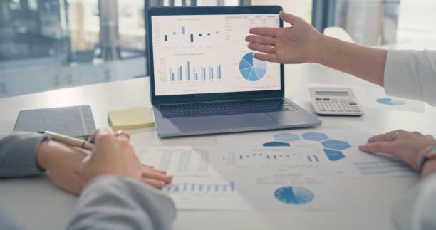 istock Partnership consulting accounting on graph or chart and laptop during a meeting in a corporate finance office. Team leader coaching or manager planning online data and analyzing marketing research 1419699765