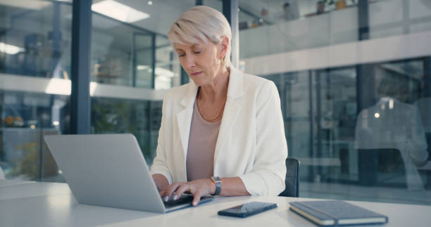 istock Manager, leader or boss working on laptop in a corporate office planning a strategy with online app. Business woman doing research on the web or internet while reading email on company technology 1419702947