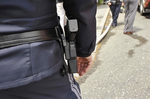 a police officer in police uniform with his service weapon