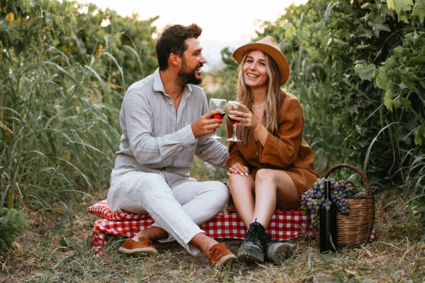 istock Couple clinking red wine glass in a Vineyard during sunset. 1419705075