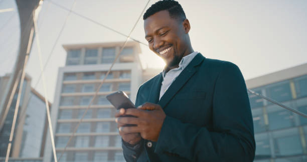 istock Happy networking and internet businessman with phone getting notification email on communication app in urban city with corporate building in background. Ecommerce entrepreneur checking online sales 1419709217