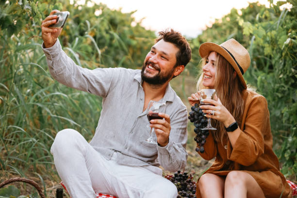 istock Couple clinking red wine glass in a Vineyard during sunset. 1419711010