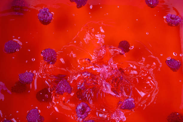 raspberry and ripe juice splash splashing liquid fresh fruits berries water background