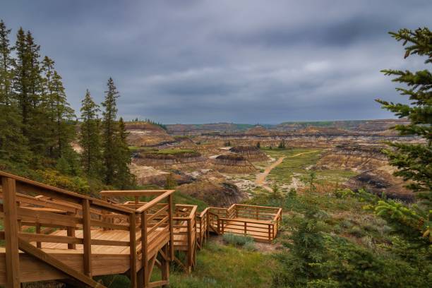Moody Clouds Over Horseshoe Canyon A panoramic cloudy sky over Horseshoe Canyon in Drumheller. drumheller stock pictures, royalty-free photos & images