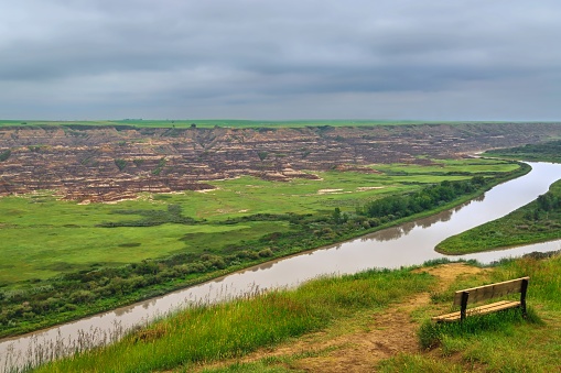 A panoramic cloudy sky over a lookout of the Red Deer River in Drumheller in the summer.