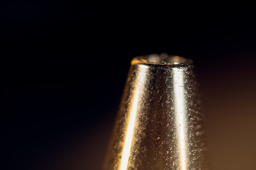 Bottle and glass of yellow champagne on yellow background