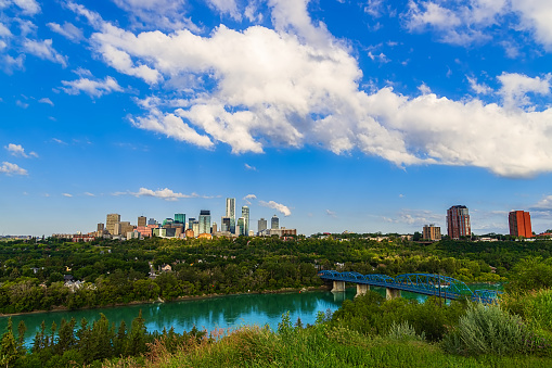 A bright blue sky over the Edmonton skyline and river valley in the summer.