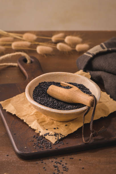 istock Black sesame seeds in a ceramic bowl 1419716994