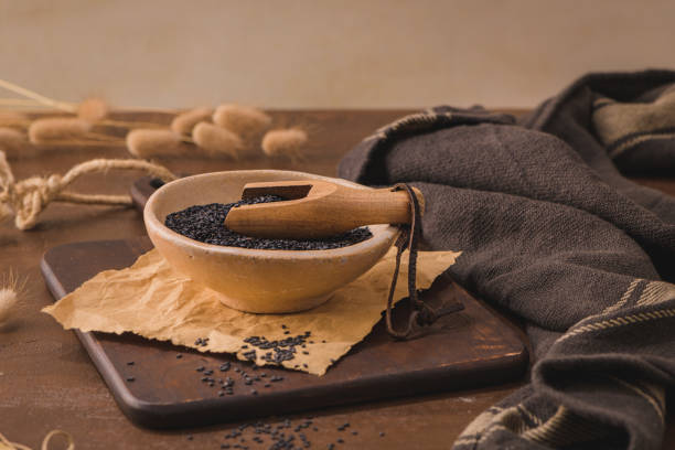 istock Black sesame seeds in a ceramic bowl 1419717007