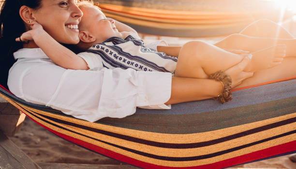 istock Mother and son lie in a swing on the beach 1419718566
