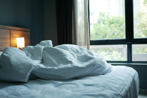istock messy bed in early morning , messy bed after waking up 1419719470