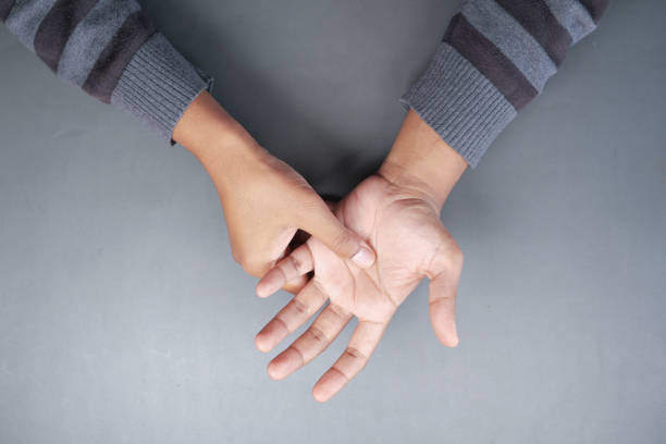 istock man suffering pain in hand top view 1419720694