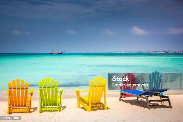 Colorful Chairs In Aruba Turquoise Caribbean Beach With Ship Dutch Antilles Stock Photo - Download Image Now