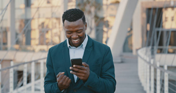 istock Happy, excited and success while reading phone message with business man celebrating being a winner and cheering for investment growth outside. Lucky entrepreneur getting good news using fintech app 1419726675