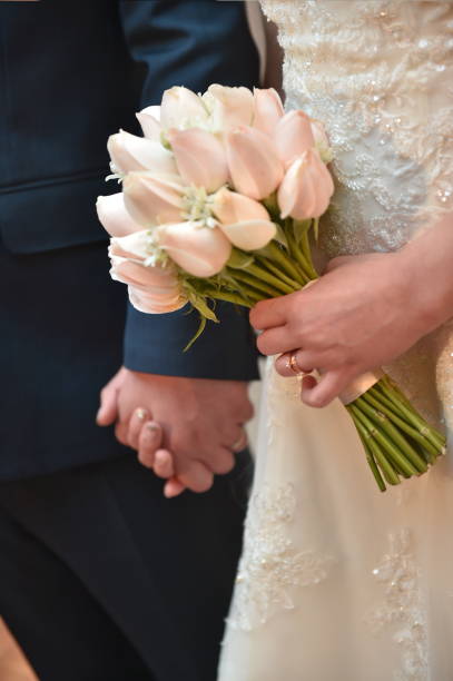 istock Two people are together holding hands, having wedding ceremony. 1419730542