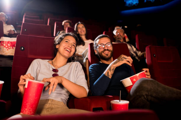 istock Young couple discussing while watching a movie at the cinema 1419730672