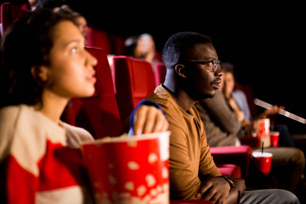 girl watching a movie at the cinema - audience surprise movie theater shock imagens e fotografias de stock