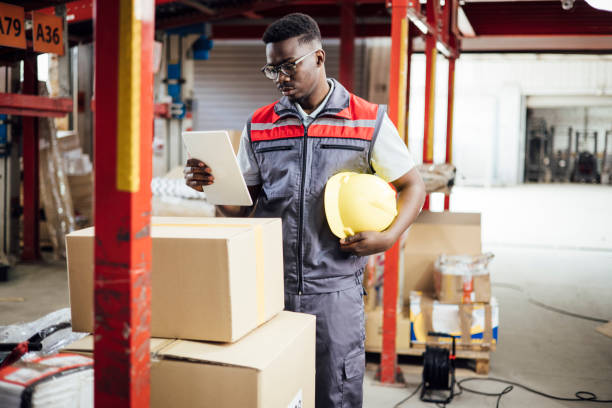 istock African American warehouse worker storing cardboard boxes 1419731317