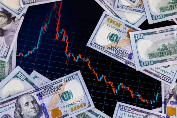 istock US dollar banknote stacks over digital screen with exchange chart, depreciation and volatility concept, close-up perspective view 1419732139