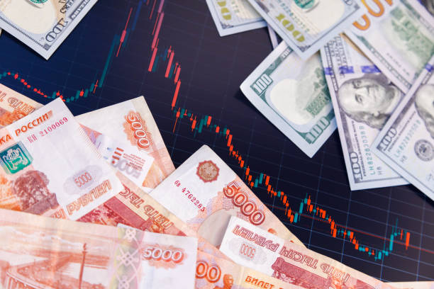 istock US dollar and russian ruble banknotes over digital screen with exchange chart, USD RUB depreciation concept 1419732142