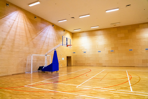 Goals for mini-football and a mobile movable basket in basketball sports hall.