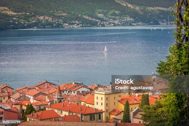 Village And Sailboats On Lake Como Near Bellagio At Sunset Italy Stock Photo - Download Image Now