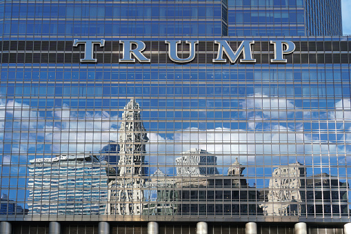 Chicago, USA - August 31, 2022:  The mirrored facade of the Chicago Trump tower reflects buildings across the river.