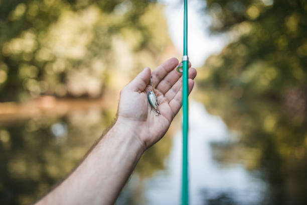 An unrecognizable man spends the day enjoying his favorite hobby, fishing